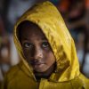 UNICEF/UN0372373/Ocon/AFP-Services A girl protects herself from the heavy rains by wearing a raincoat as she returns home from a shelter after the passage of Hurricane Iota in Nicaragua, in Bilwi, on November 16, 2020.